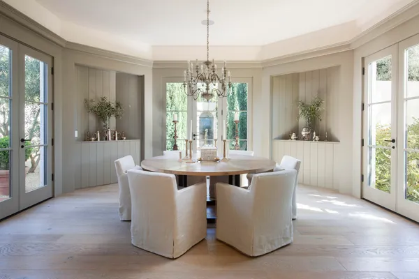 a view of a dining room with furniture large windows and wooden floor