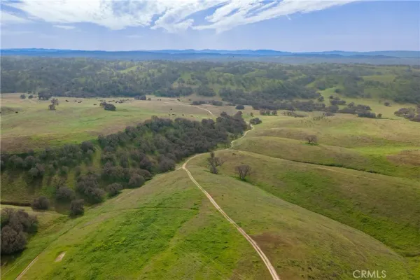 a view of a field with an ocean view