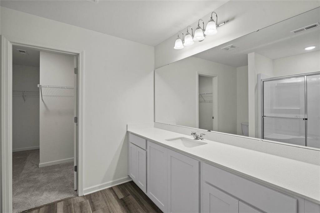212 Champions Boulevard Dallas, GA 30157 - Photo 14 of 19 a bathroom with a sink and a mirror