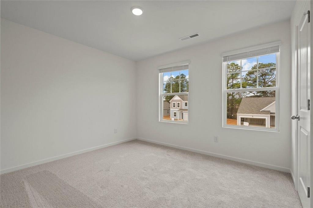 212 Champions Boulevard Dallas, GA 30157 - Photo 16 of 19 an empty room with windows