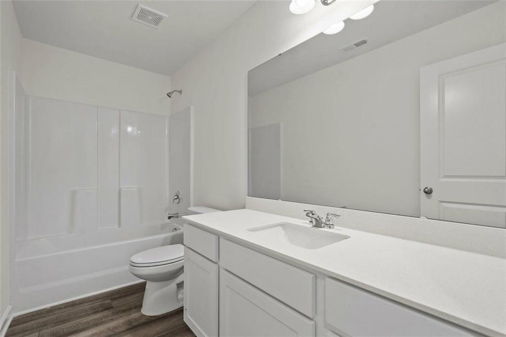 212 Champions Boulevard Dallas, GA 30157 - Photo 17 of 19 a bathroom with a sink toilet and shower