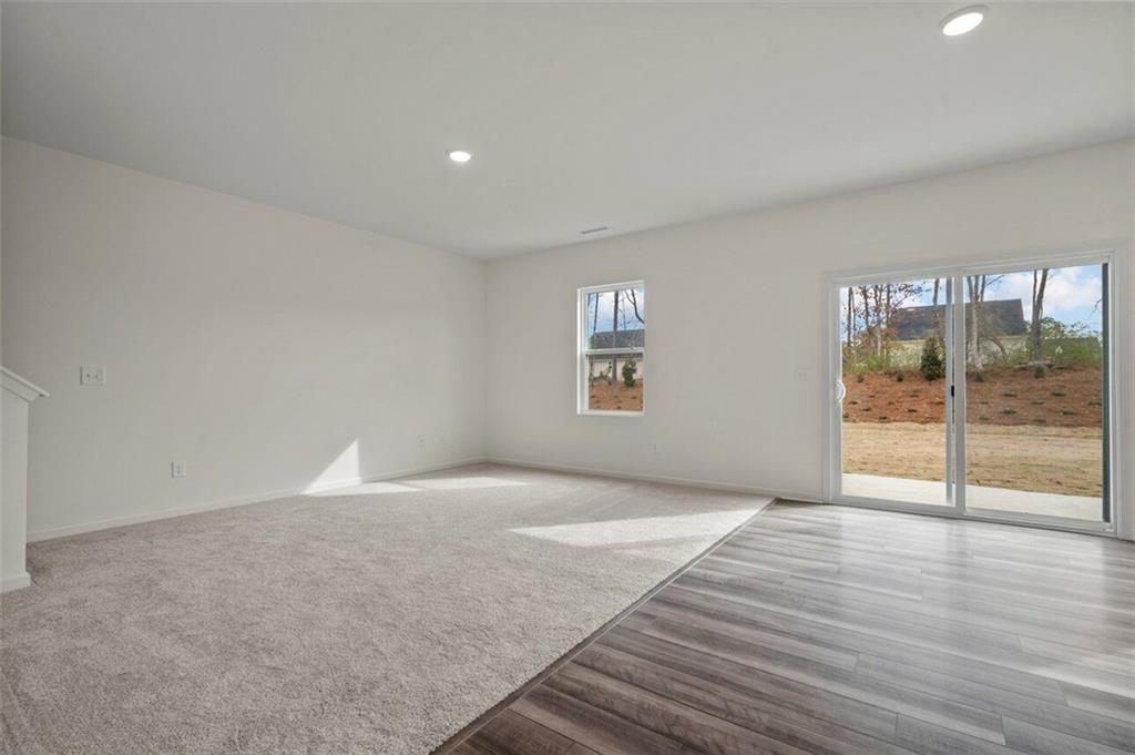 212 Champions Boulevard Dallas, GA 30157 - Photo 9 of 19 an empty room with wooden floor and windows