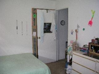 241 Kentucky Street Vallejo, CA 94590 - Photo 7 of 8 a bedroom with a bed and a dresser in it