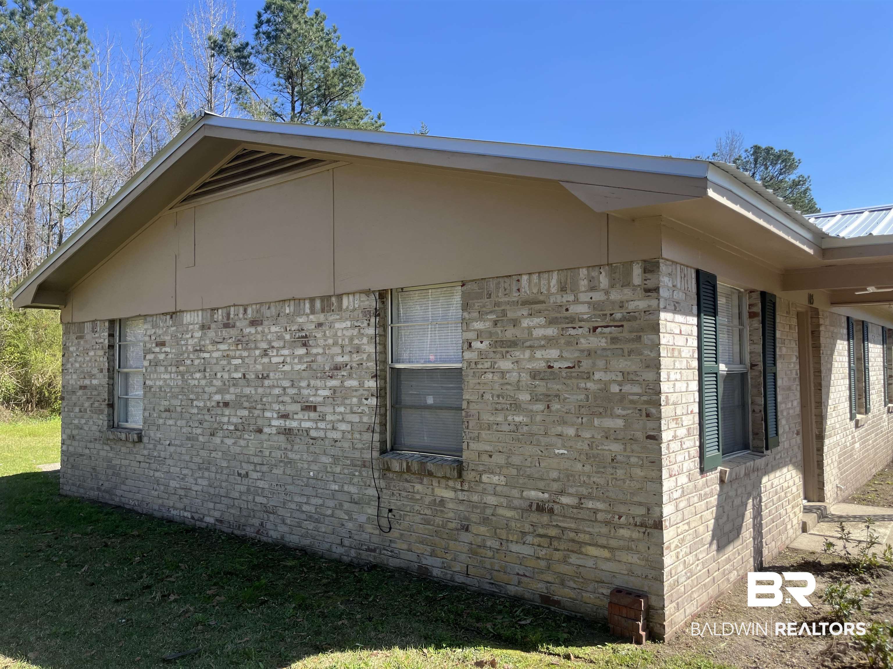 103 Roadway Street Brewton, AL 36426 - Photo 3 of 13 View of property exterior featuring brick siding