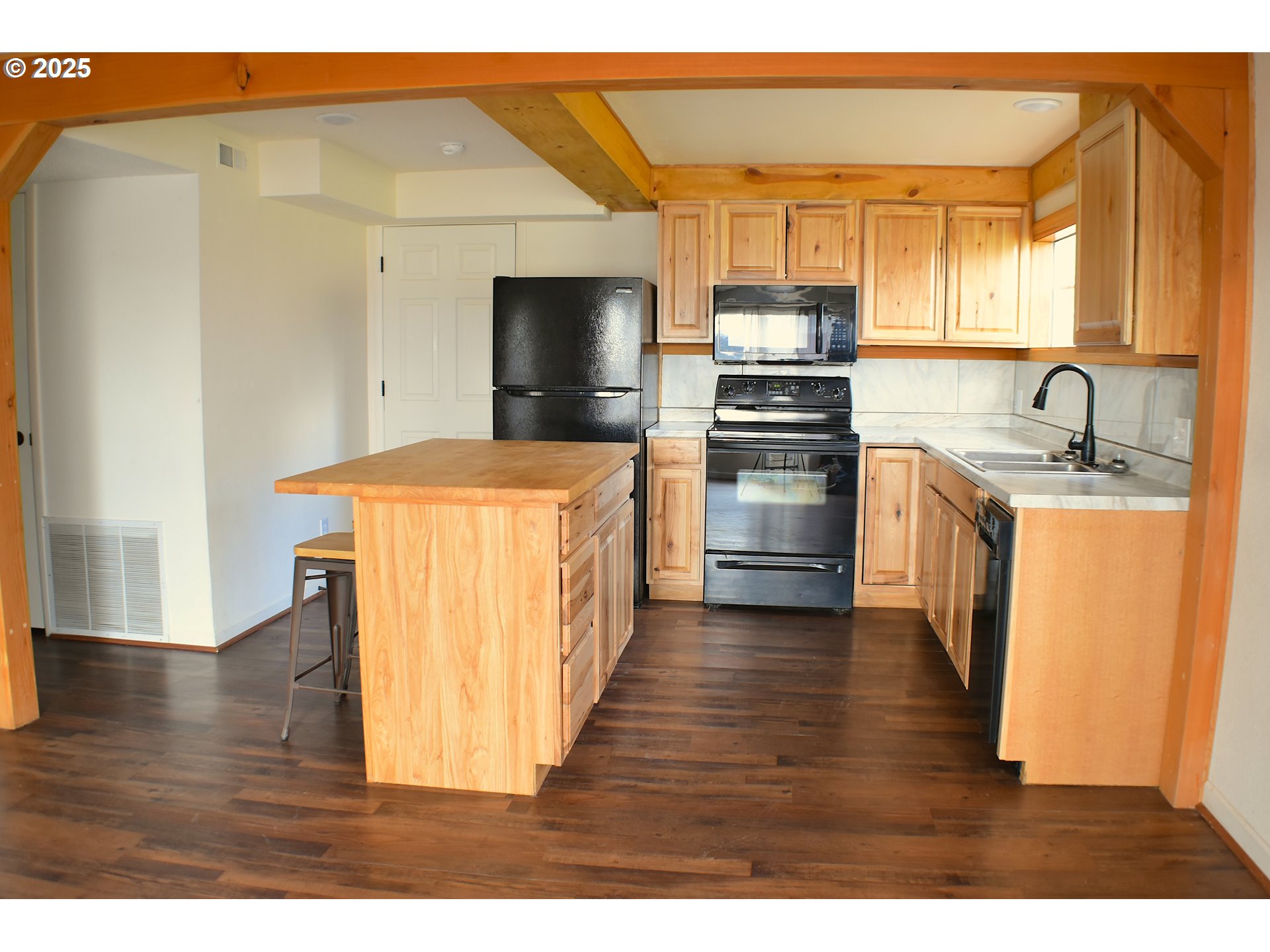 905 North E Barnes Butte Road Prineville, OR 97754 - Photo 3 of 11 a kitchen with stainless steel appliances granite countertop a stove top oven a sink and a refrigerator