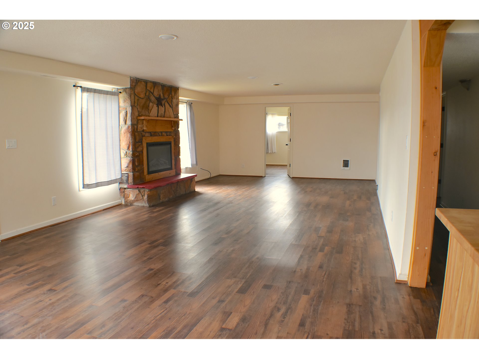 905 North E Barnes Butte Road Prineville, OR 97754 - Photo 4 of 11 a view of an empty room with wooden floor and a window