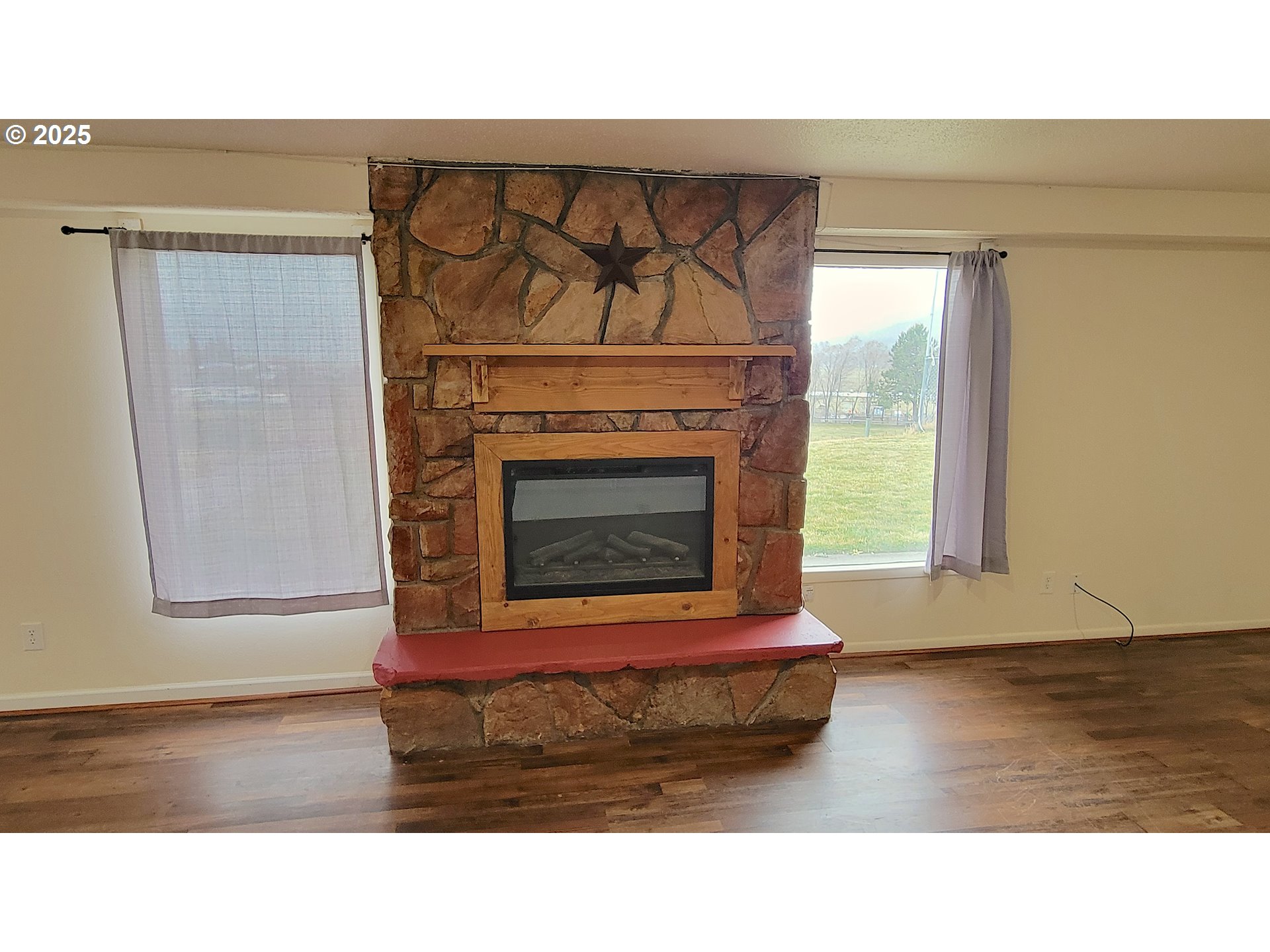905 North E Barnes Butte Road Prineville, OR 97754 - Photo 6 of 11 a black and white photo of a fireplace