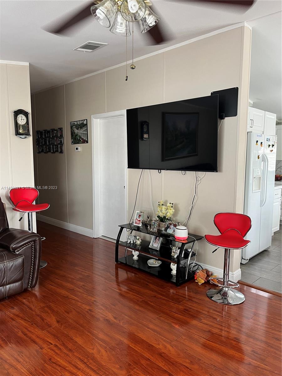 28501 Southwest 152nd Avenue Homestead, FL 33033 - Photo 11 of 32 a living room with furniture a flat screen tv and a couch