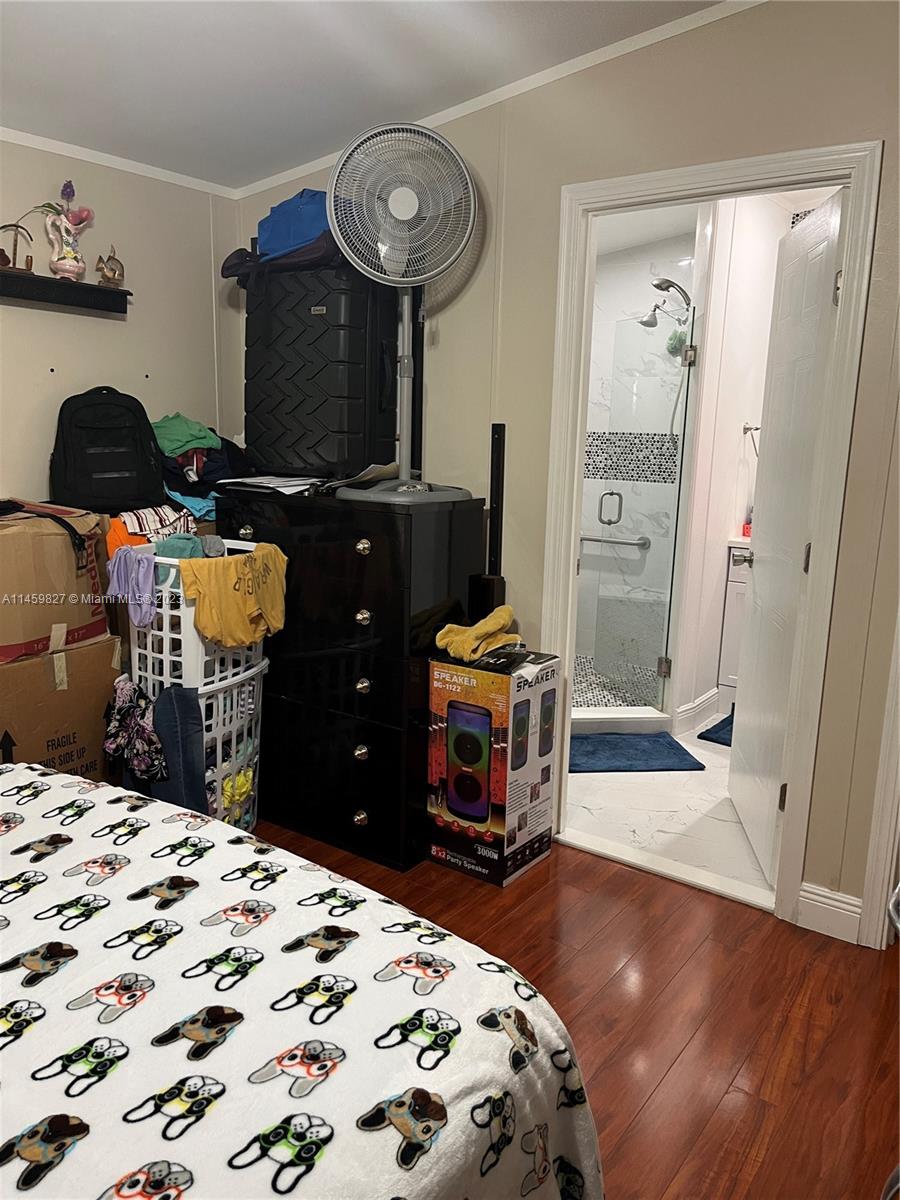 28501 Southwest 152nd Avenue Homestead, FL 33033 - Photo 13 of 32 a bedroom with a bed and a mirror on the dresser