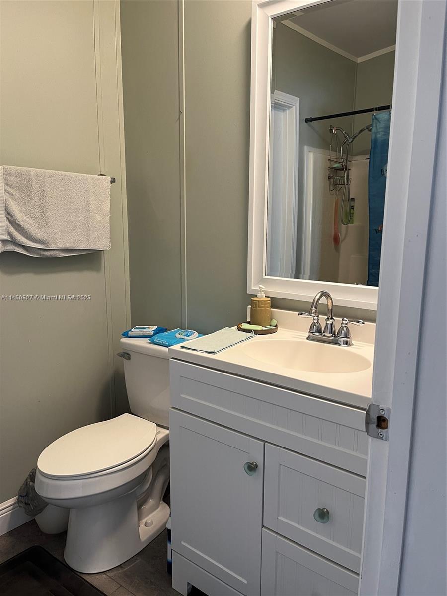 28501 Southwest 152nd Avenue Homestead, FL 33033 - Photo 19 of 32 a bathroom with a granite countertop toilet sink and mirror