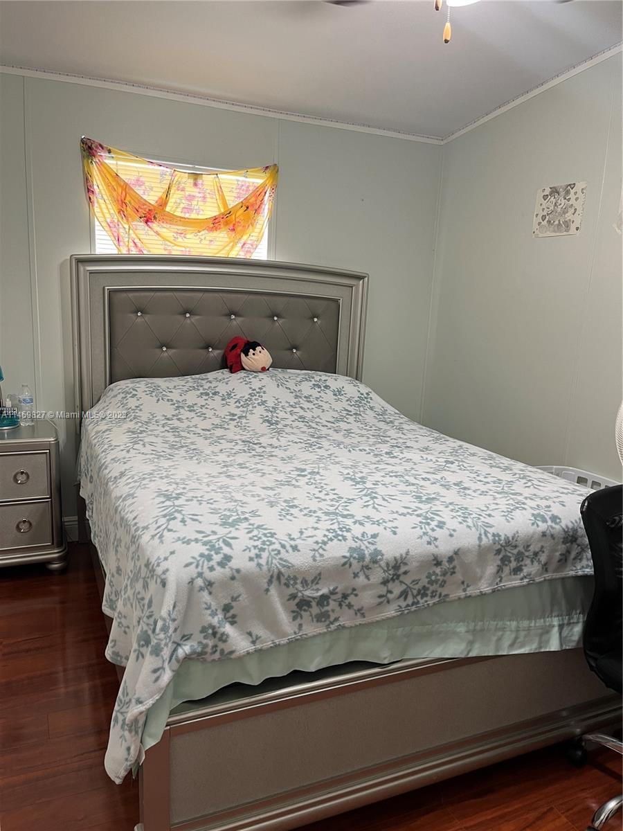 28501 Southwest 152nd Avenue Homestead, FL 33033 - Photo 22 of 32 a bed sitting in a bedroom next to a window