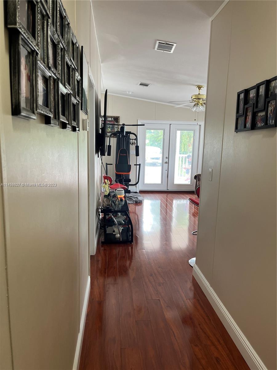 28501 Southwest 152nd Avenue Homestead, FL 33033 - Photo 24 of 32 a view of a hallway with wooden floor and living room