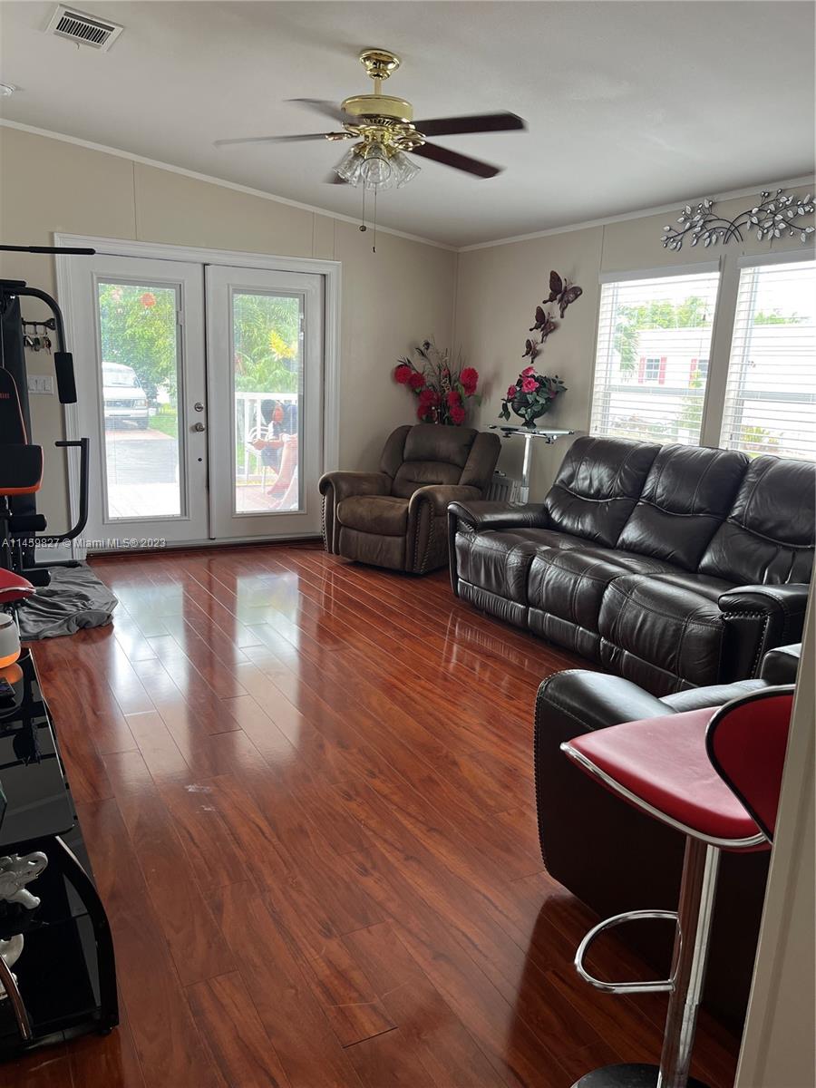 28501 Southwest 152nd Avenue Homestead, FL 33033 - Photo 25 of 32 a living room with furniture a flat screen tv and a large window