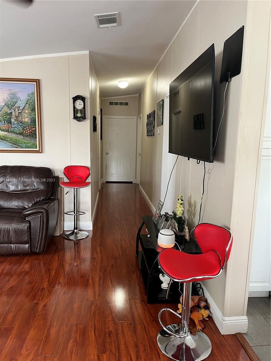 28501 Southwest 152nd Avenue Homestead, FL 33033 - Photo 26 of 32 a room with furniture and wooden floor