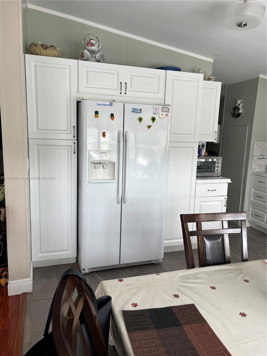 28501 Southwest 152nd Avenue Homestead, FL 33033 - Photo 3 of 32 a kitchen with a refrigerator and table