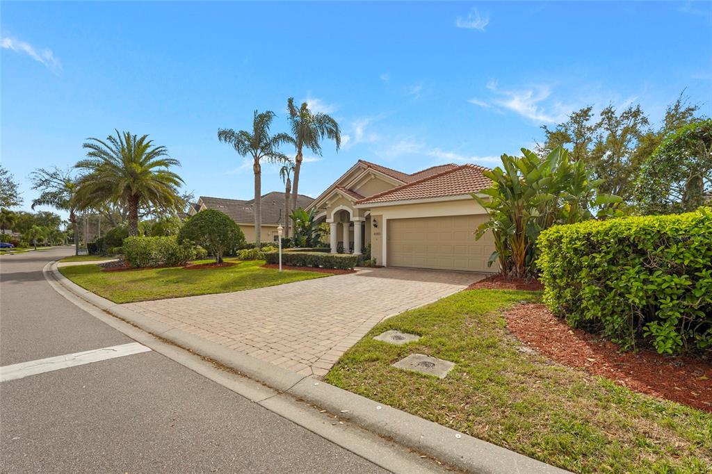 6582 Waters Edge Way Lakewood Ranch, FL 34202 - Photo 2 of 98 a front view of a house with a yard and garage
