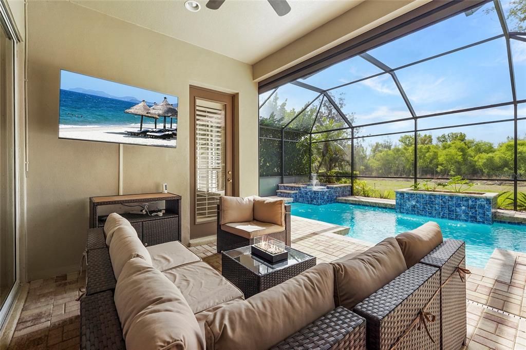 6582 Waters Edge Way Lakewood Ranch, FL 34202 - Photo 53 of 98 a living room with furniture and a floor to ceiling window