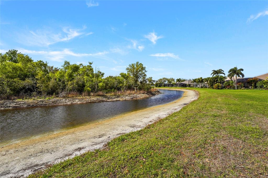 6582 Waters Edge Way Lakewood Ranch, FL 34202 - Photo 59 of 98 a view of a lake with houses in the back