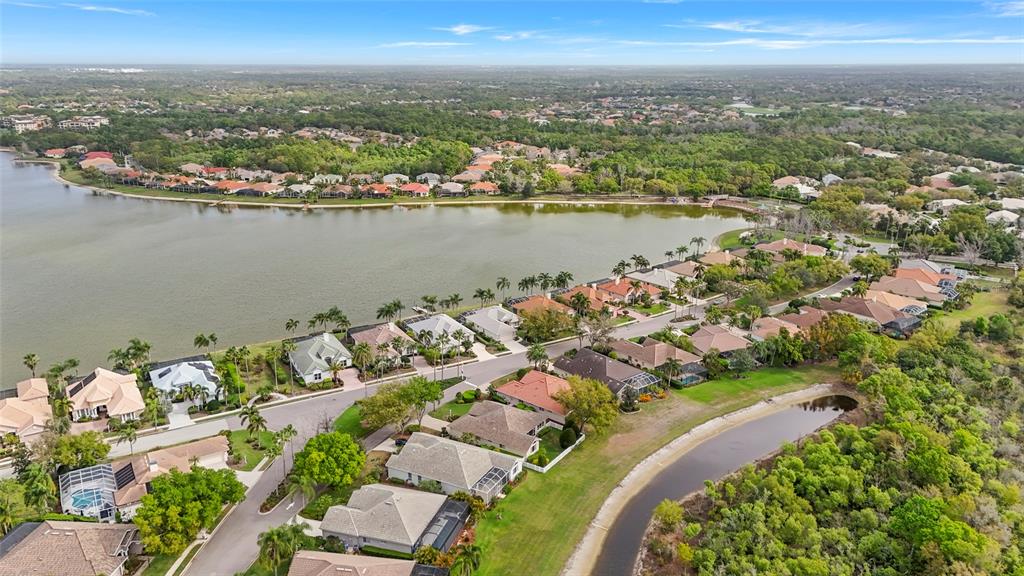 6582 Waters Edge Way Lakewood Ranch, FL 34202 - Photo 64 of 98 an aerial view of a city with lots of residential buildings ocean and mountain view in back