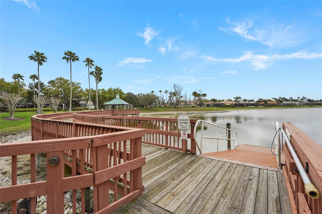 6582 Waters Edge Way Lakewood Ranch, FL 34202 - Photo 72 of 98 a view of a roof deck with lake view and wooden floor