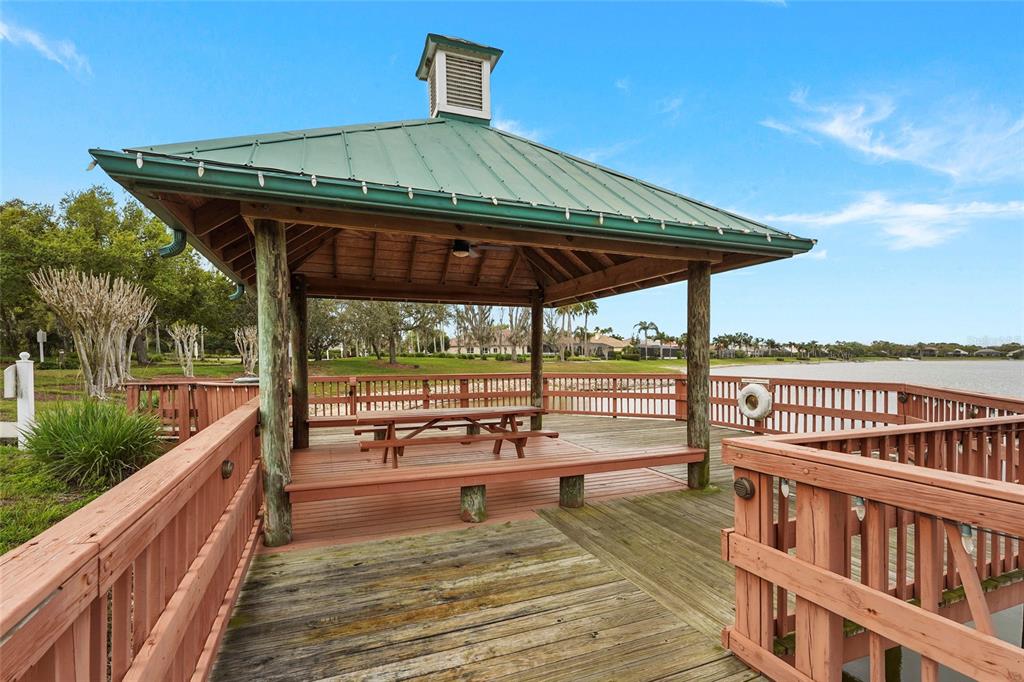 6582 Waters Edge Way Lakewood Ranch, FL 34202 - Photo 74 of 98 a view of a balcony with lake view and wooden floor