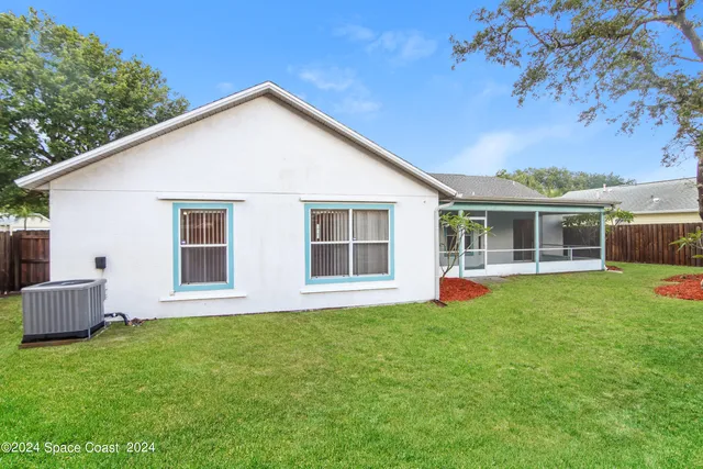 a view of a house with a yard and sitting area