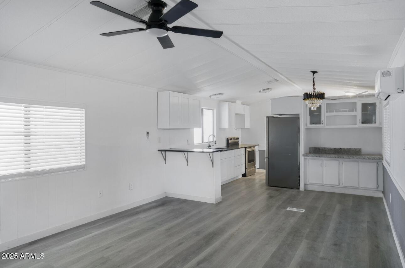 805 North Dysart Road, Unit 33 Avondale, AZ 85323 - Photo 12 of 18 a view of a kitchen with wooden floor and a kitchen