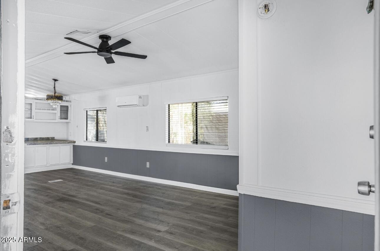 805 North Dysart Road, Unit 33 Avondale, AZ 85323 - Photo 18 of 18 a view of an empty room with window and wooden floor