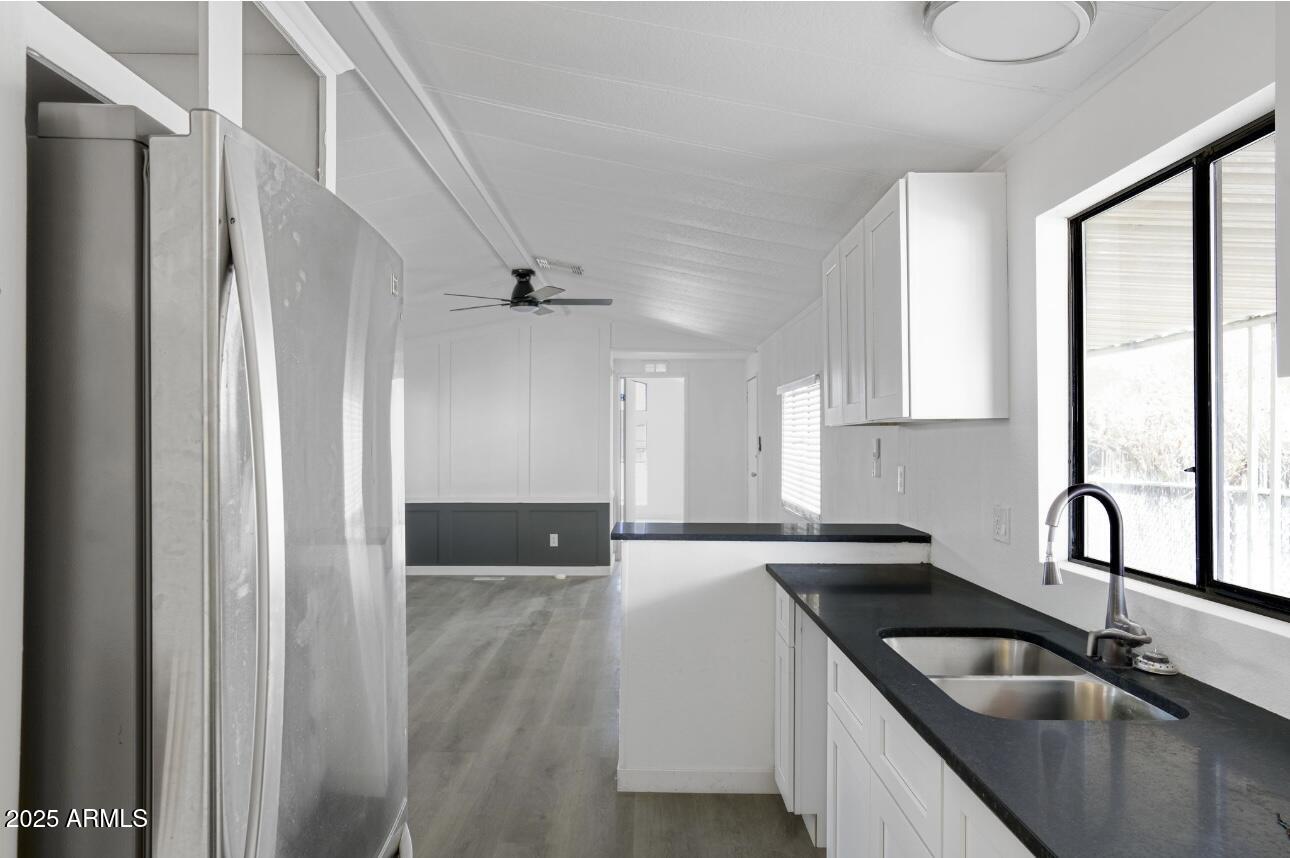 805 North Dysart Road, Unit 33 Avondale, AZ 85323 - Photo 10 of 18 a kitchen with granite countertop a sink and a refrigerator