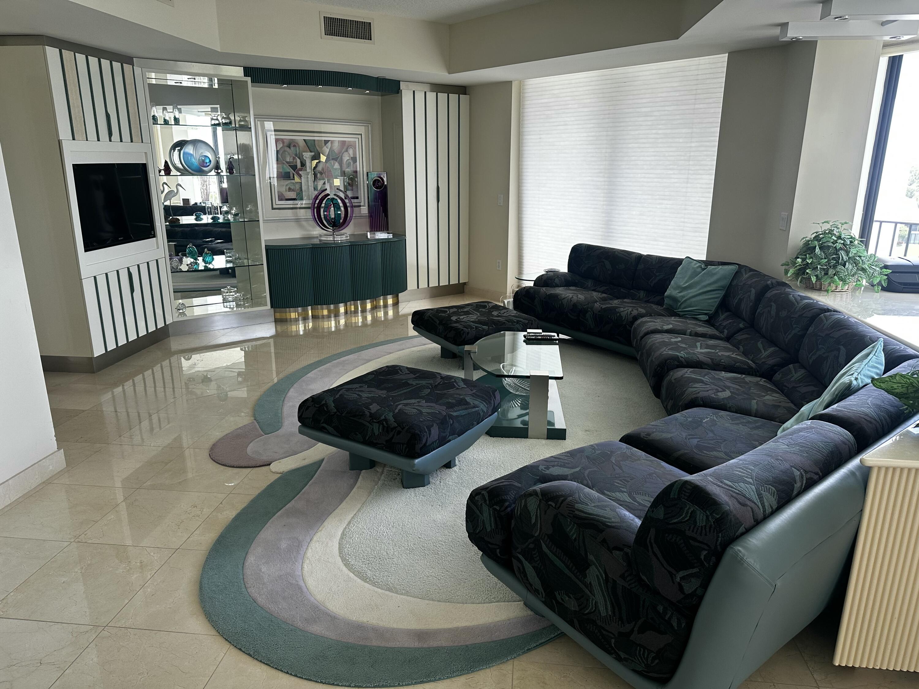 20320 Fairway Oaks Drive, Unit 373 Boca Raton, FL 33434 - Photo 16 of 27 a living room with furniture and a flat screen tv