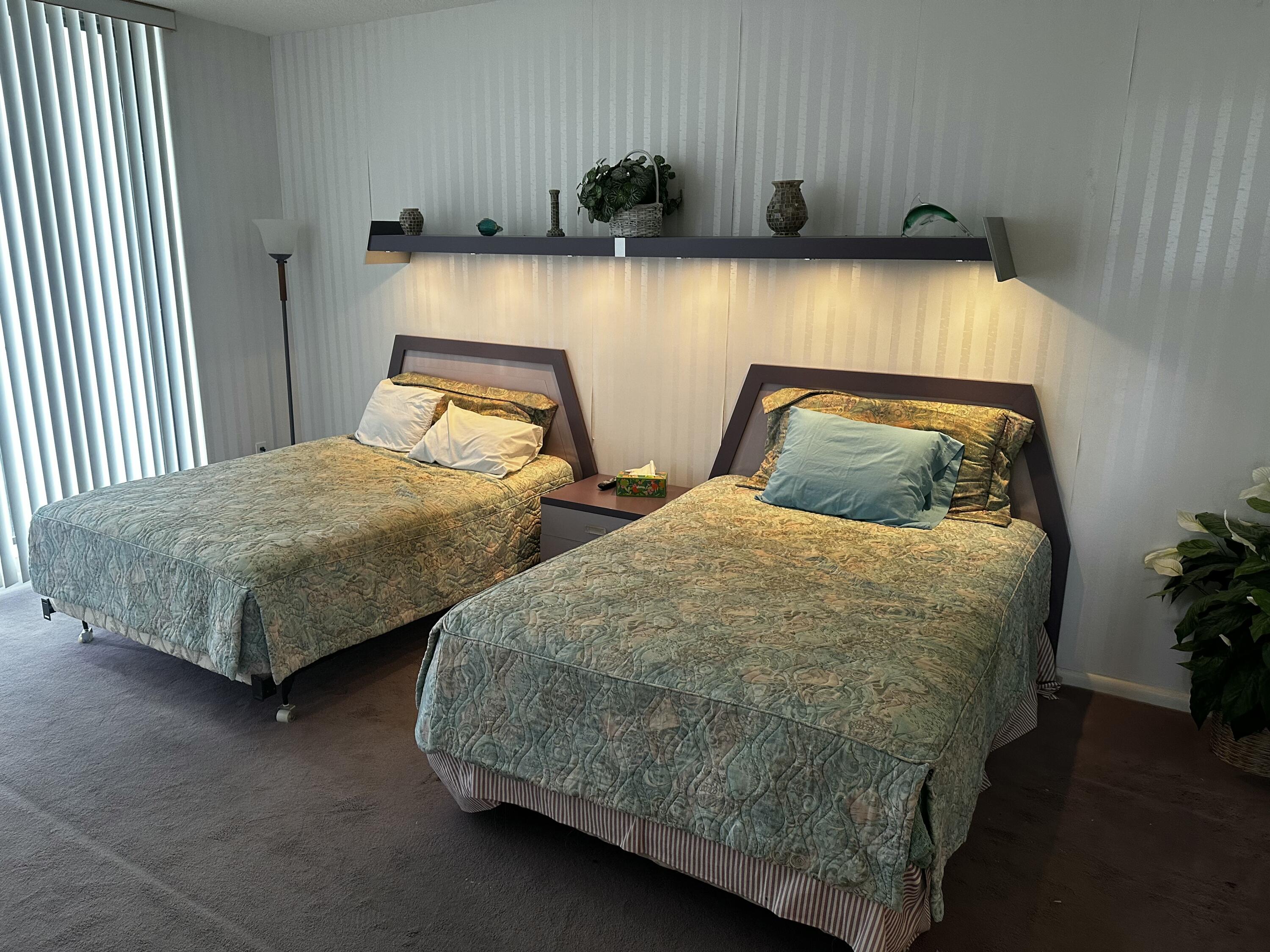 20320 Fairway Oaks Drive, Unit 373 Boca Raton, FL 33434 - Photo 26 of 27 a bedroom with two beds and painted walls