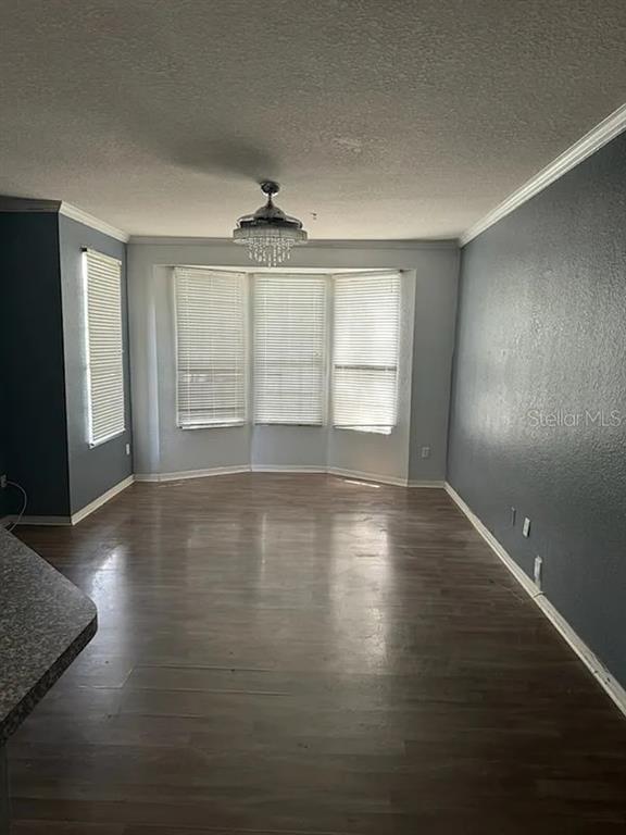 6392 Raleigh Street, Unit 2801 Orlando, FL 32835 - Photo 4 of 11 a view of wooden floor and windows in an empty room