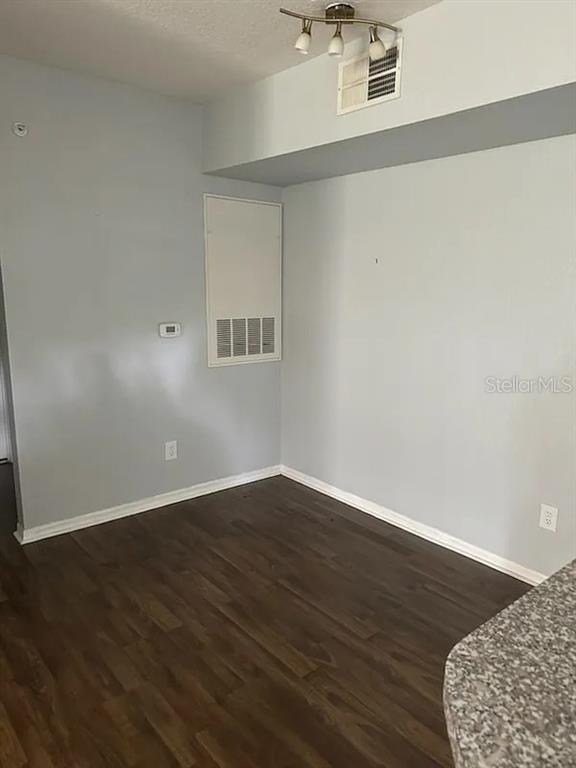 6392 Raleigh Street, Unit 2801 Orlando, FL 32835 - Photo 5 of 11 a view of an empty room with wooden floor