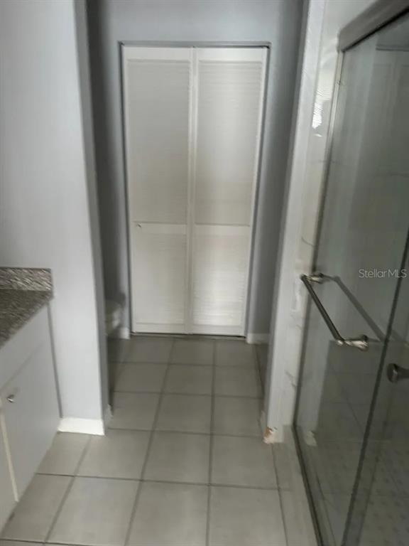 6392 Raleigh Street, Unit 2801 Orlando, FL 32835 - Photo 9 of 11 a bathroom with a glass door shower and a sink