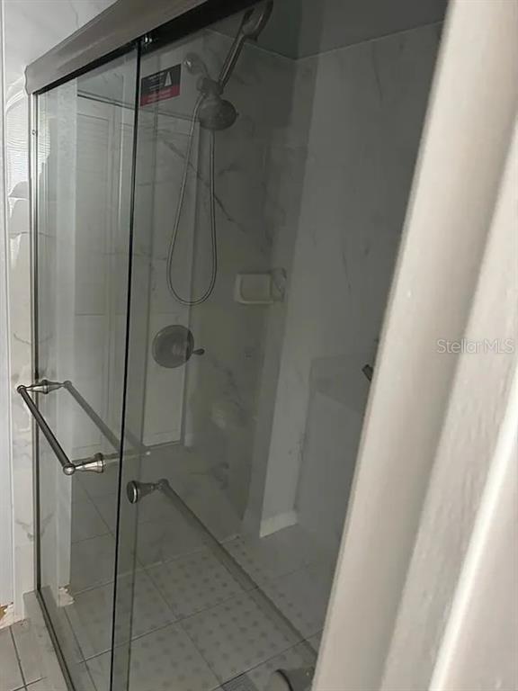 6392 Raleigh Street, Unit 2801 Orlando, FL 32835 - Photo 10 of 11 a bathroom with a glass door shower