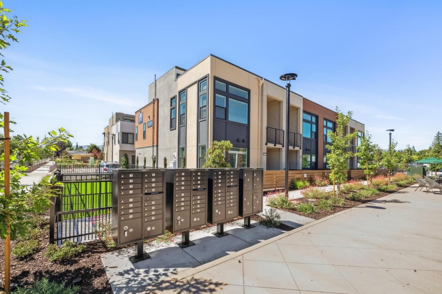 11155 Maple Place, Unit 3407 PLAN 3 Saratoga, CA 95070 - Photo 12 of 15 a view of a brick building next to a yard