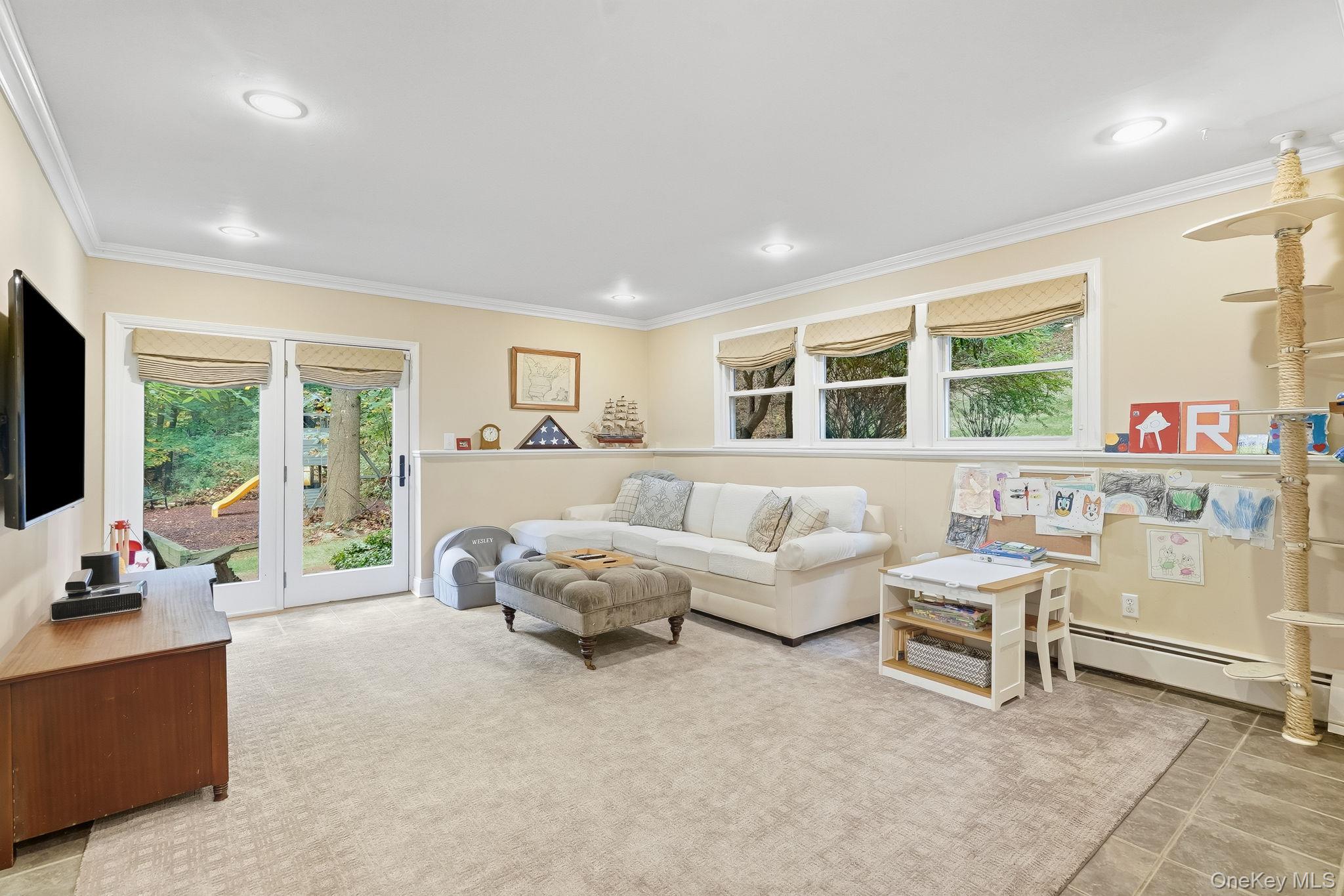 37 Tulip Road Briarcliff Manor, NY 10510 - Photo 16 of 27 a living room with furniture and a flat screen tv