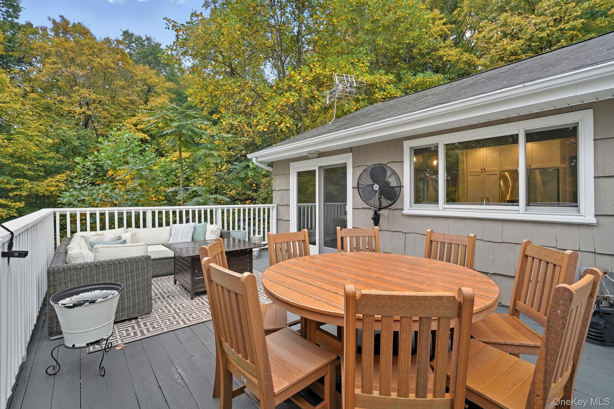 37 Tulip Road Briarcliff Manor, NY 10510 - Photo 21 of 27 a view of a patio with table and chairs with wooden floor and fence