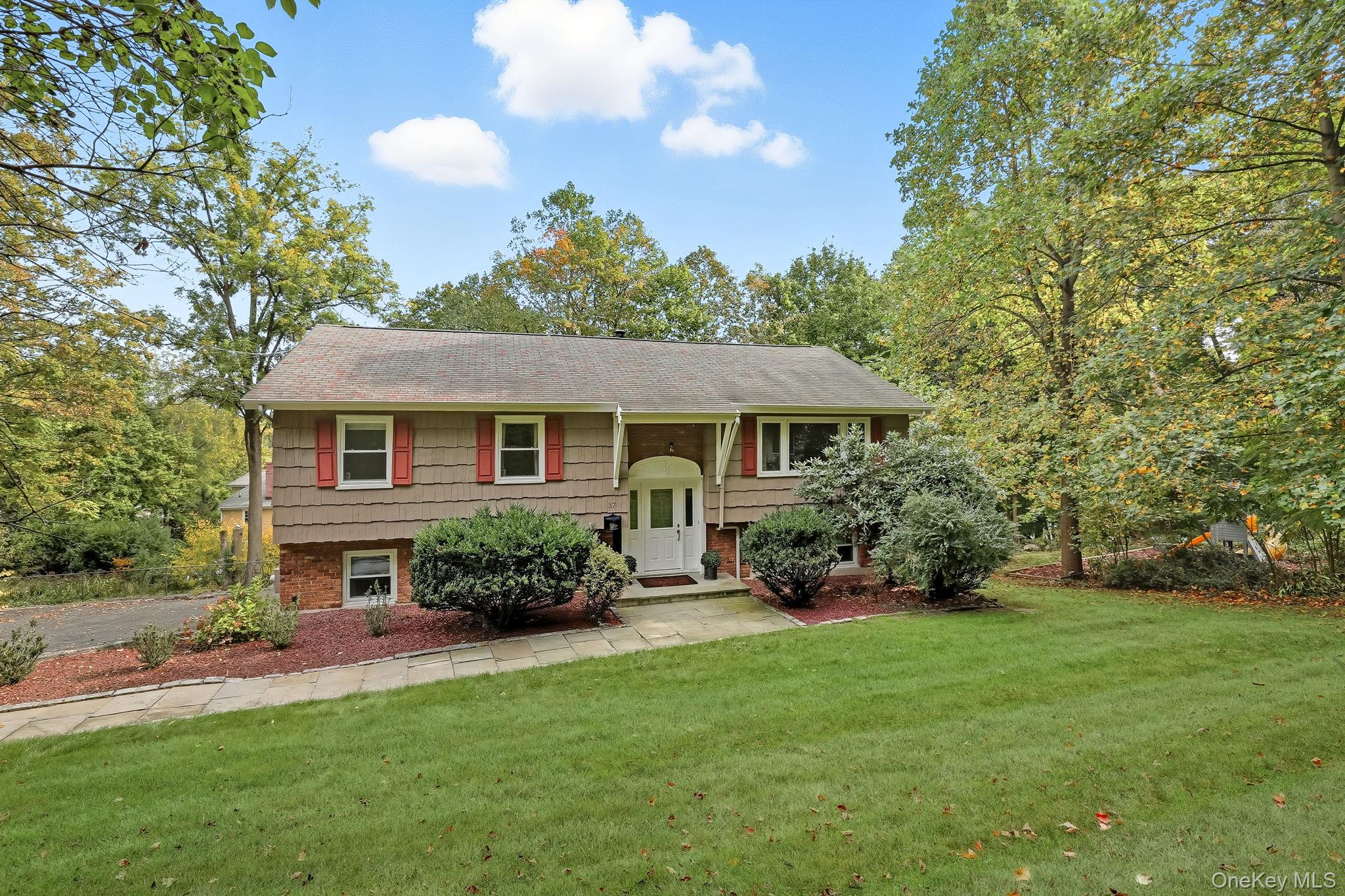 37 Tulip Road Briarcliff Manor, NY 10510 - Photo 25 of 27 a front view of a house with a garden and porch