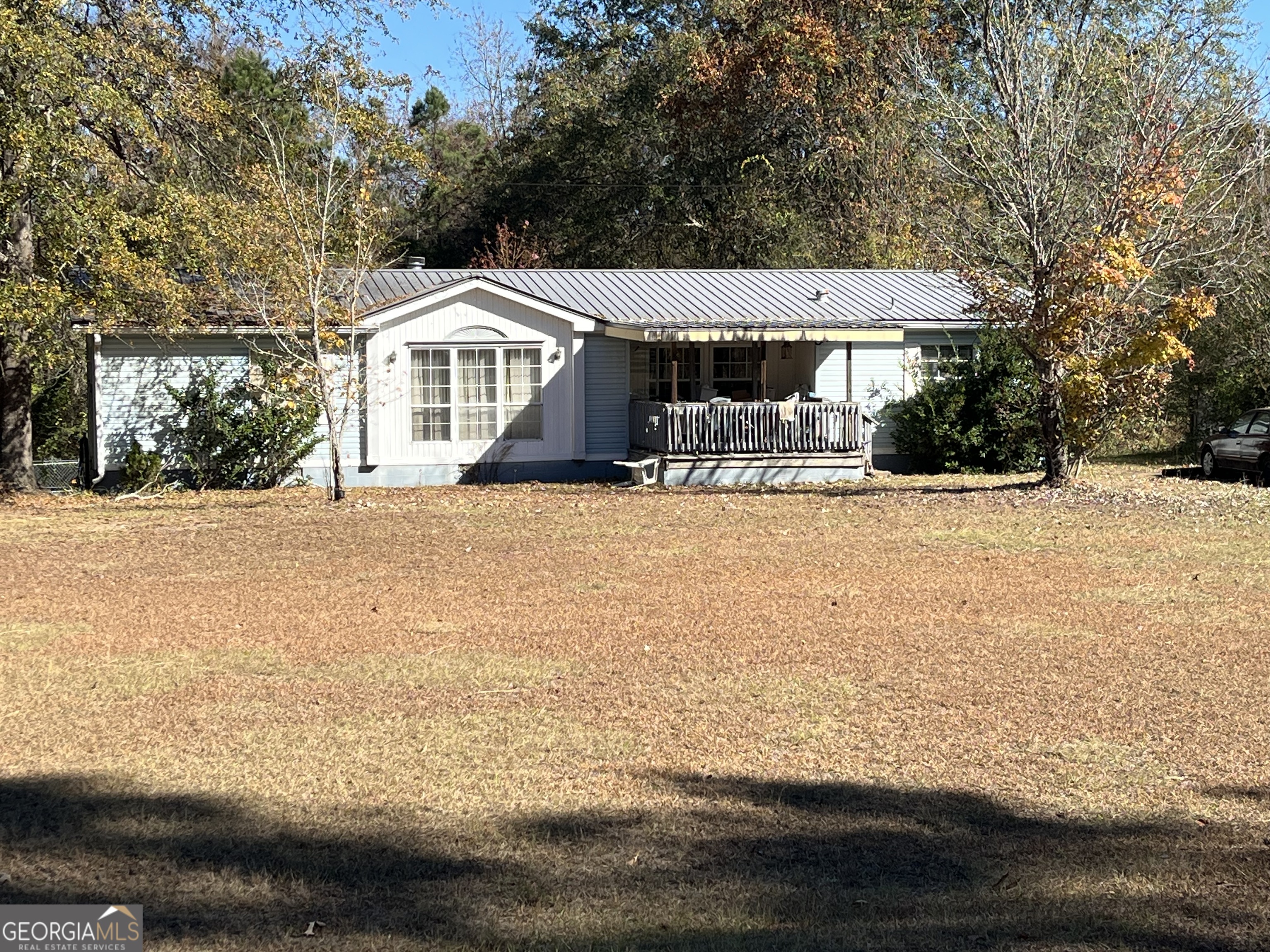 6330 Riggins Mill Road Dry Branch, GA 31020 - Photo 18 of 108 a front view of a house with a yard covered with snow