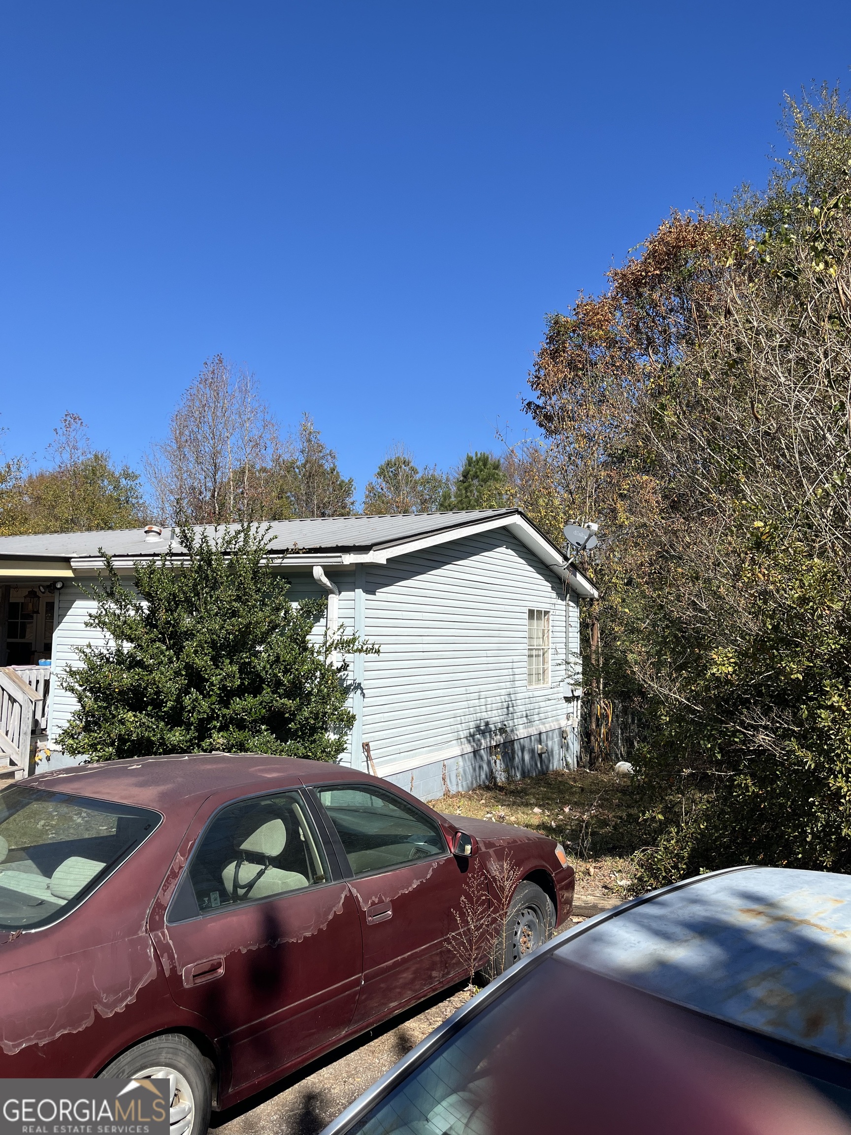 6330 Riggins Mill Road Dry Branch, GA 31020 - Photo 23 of 108 a view of a yard with plants and a table and chair
