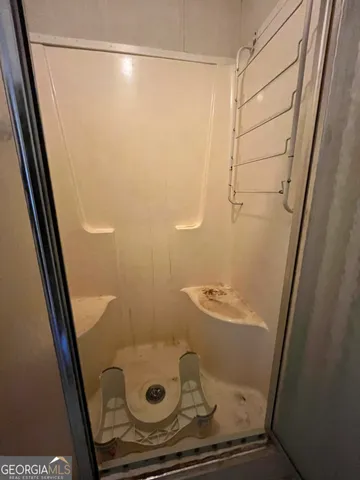 an aerial view of house with yard and mountain view in back