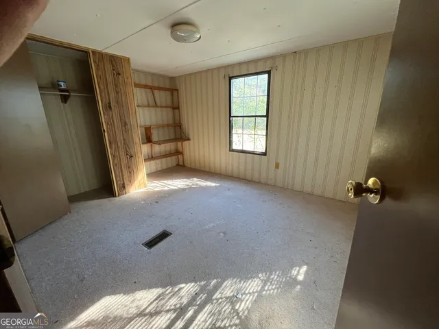 a front view of a house with a yard covered with snow