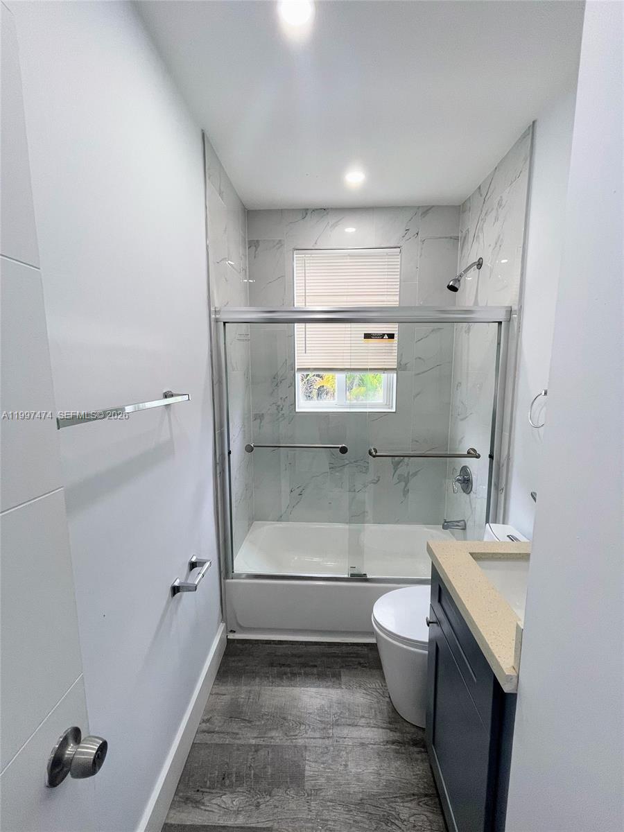 1036 Southwest 5th Street, Unit 8 Miami, FL 33130 - Photo 5 of 13 a bathroom with a sink a toilet and shower