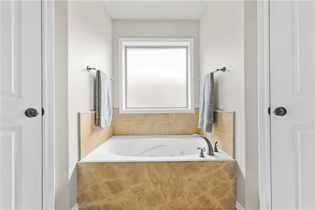 a bathroom with a tub and a shower