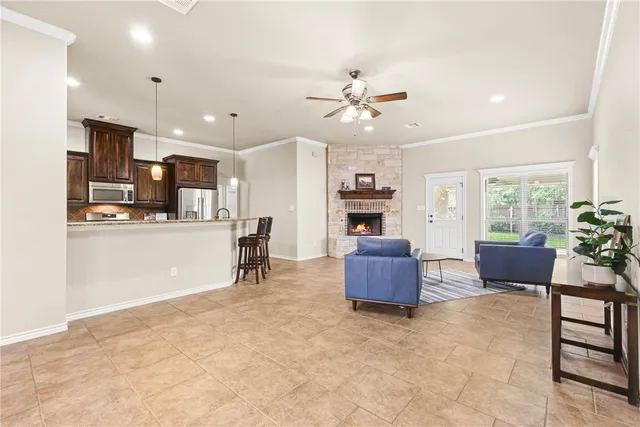 a living room with furniture and kitchen view