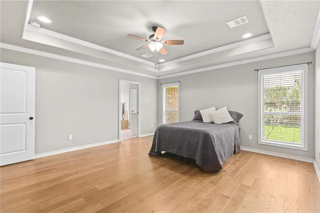 a spacious bedroom with a bed and a window