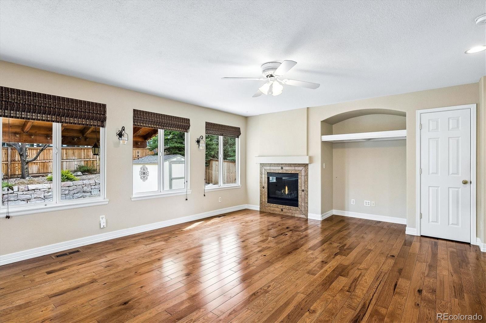 6299 Shannon Trail Highlands Ranch, CO 80130 - Photo 12 of 40 a view of an empty room with a window and wooden floor