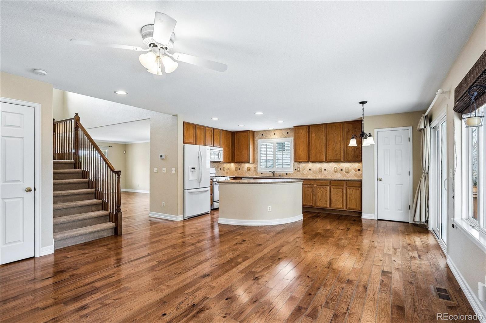 6299 Shannon Trail Highlands Ranch, CO 80130 - Photo 13 of 40 a view of kitchen with granite countertop cabinets and refrigerator