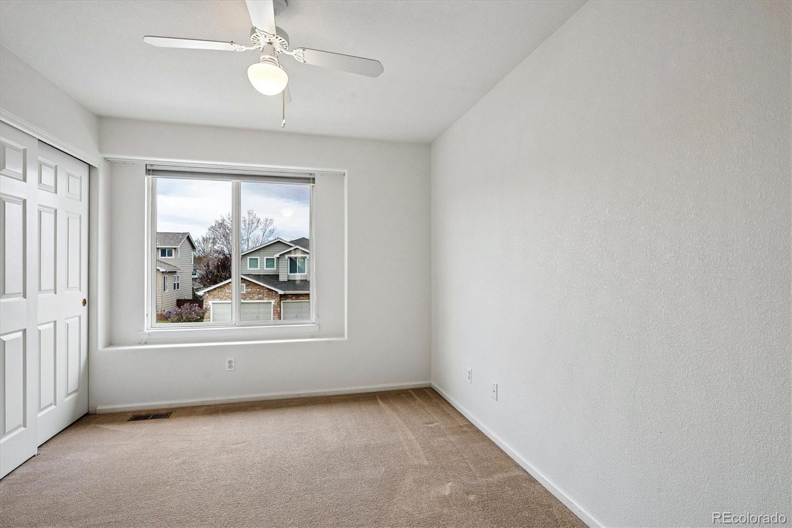 6299 Shannon Trail Highlands Ranch, CO 80130 - Photo 24 of 40 an empty room with window and ceiling fan